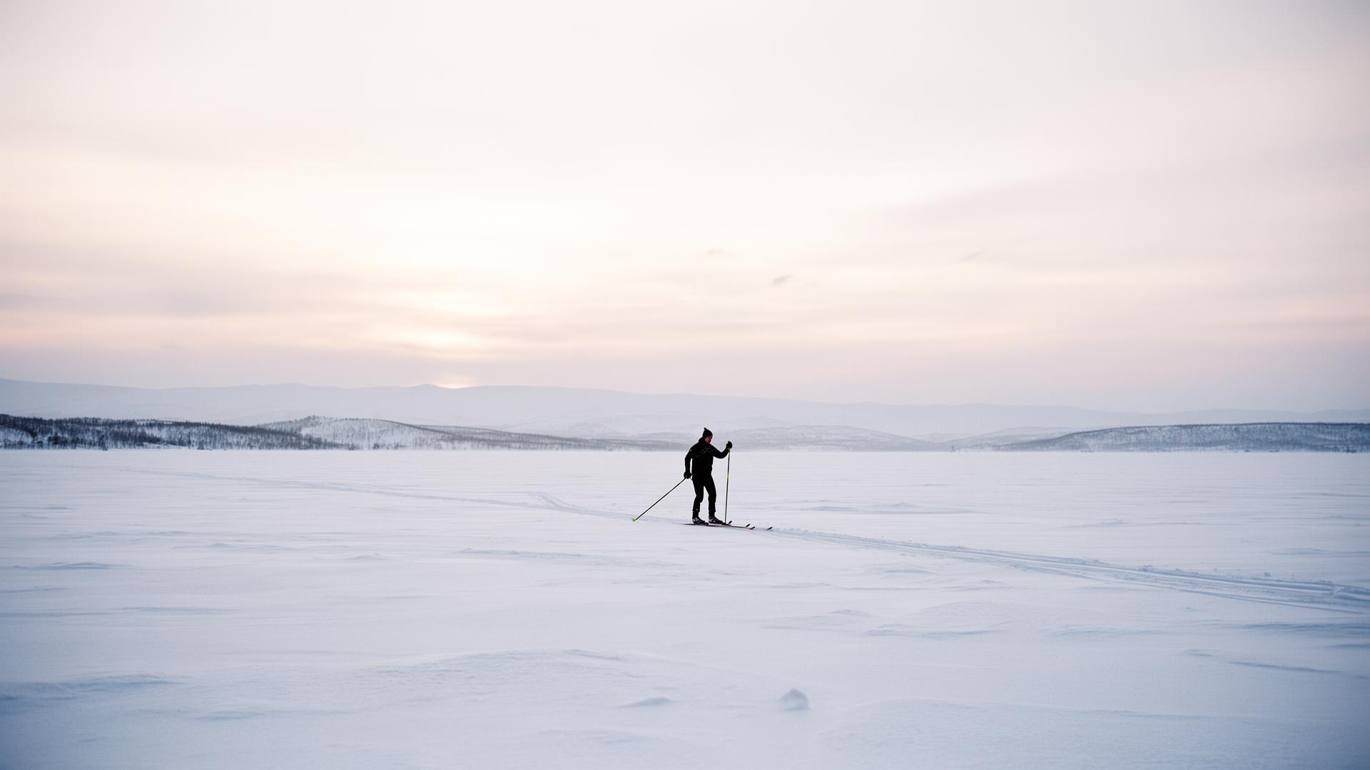 Lone cross-country skier on a snow plateau